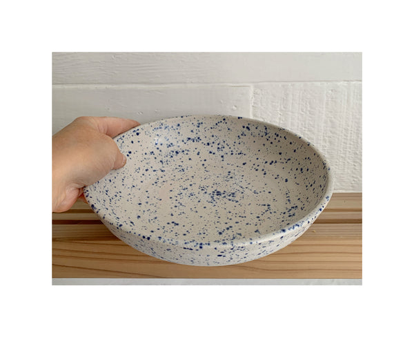 Blue speckled and matte white serving bowl